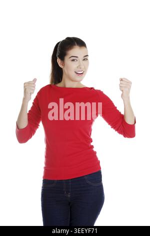 Happy, excited young woman with fists up Stock Photo
