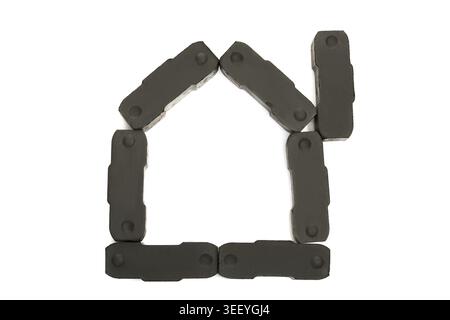 Composition of coal elements in a shape of house. Isolated on white Stock Photo