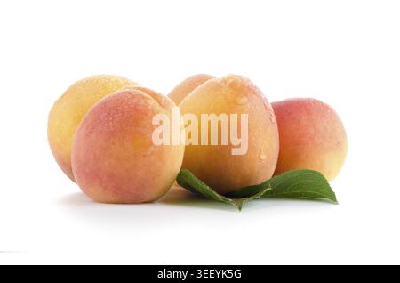 Sweet peaches with leafs on a white background Stock Photo