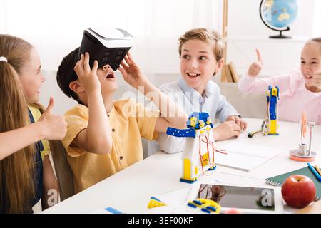 Children Engaged in Interactive Learning and Robotics During a Technology Workshop Stock Photo