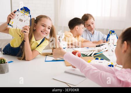 Children Engaged in Creative Robotics Activity at a Bright Indoor Space Stock Photo