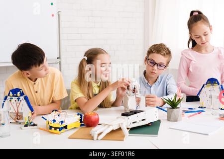 Kids Engaged in Creative Robotics Activity in Bright Classroom Setting Stock Photo
