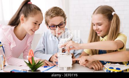 Children Engaged in Hands On Robotics Activity at a Bright Classroom Stock Photo