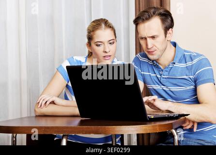 Young couple looking for something on laptop Stock Photo
