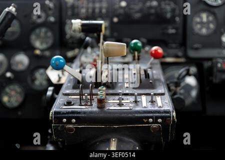 Vintage aircraft cockpit with analog controls, levers and aviation instruments inside old airplane cabin. Retro flight technology mechanical Stock Photo