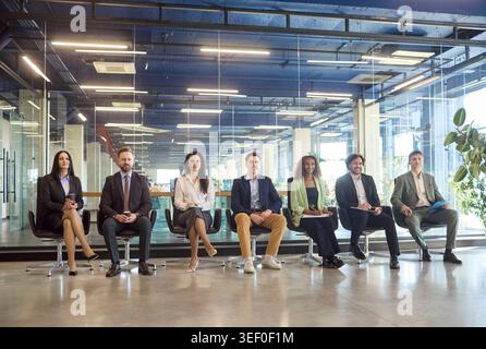 Diverse business team listening during corporate training seminar in modern office Stock Photo
