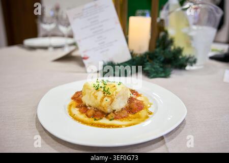 Cod cooked in sauce, served as a second course at a wedding. Andalusia, Spain Stock Photo