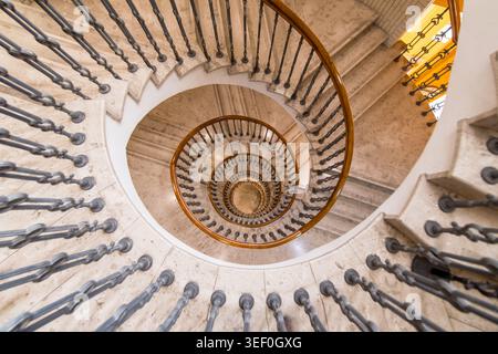 Top-Down View of Spiral Marble Staircase - Historic Curving Balustrade and Vanishing Point in Budapest Stock Photo