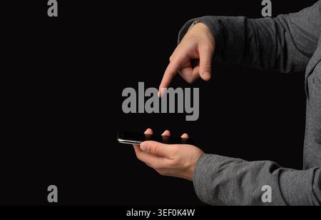 User Interacting With Smartphone Screen in Dark Setting During Evening Hours Stock Photo