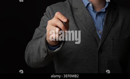 Business Individual Holding Pen in Formal Attire, Preparing to Write or Present Information Stock Photo