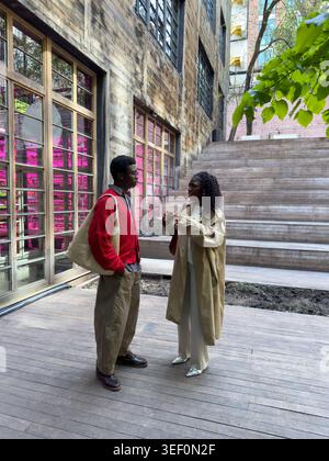 Fashionable african american man woman friends meeting in city on day break to discuss latest news. Stock Photo