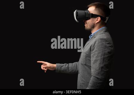 Man Uses Virtual Reality Headset With Focus on Interaction and Technology Stock Photo