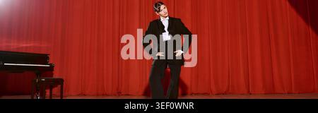 A talented young woman showcases her artistry on stage before a rich red curtain. Stock Photo