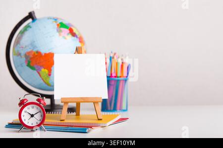 Office stationery with alarm clock on white background Stock Photo