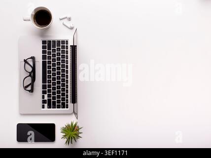 Top view of stylish workspace with laptop, coffee and cellphone Stock Photo