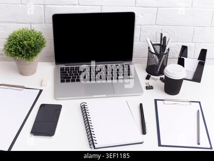 Modern workplace with laptop and notebook with copy space Stock Photo