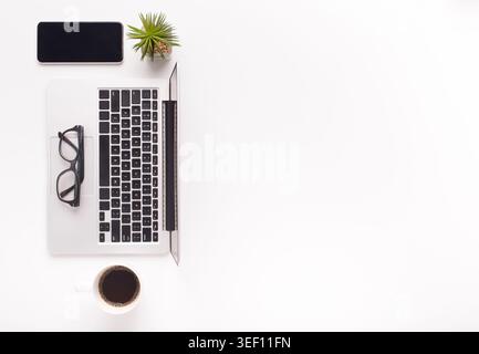 Top view of ordered desktop with laptop, coffee and cellphone Stock Photo