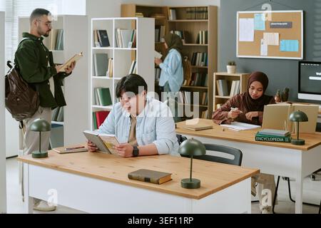 Multiethnic Students Studying in Library for Migrant Education Stock Photo