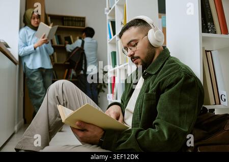 Adult Man Studying in Library for Migrant Education Program Stock Photo