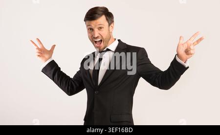 Excited Man Shouting Spreading Hands Standing On White Background Stock Photo