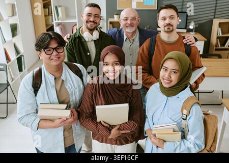 Portrait of Diverse Migrant Students and Teacher Posing at School Stock Photo