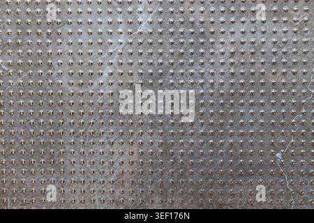Gray industrial tile texture with repeating geometric grid pattern Stock Photo