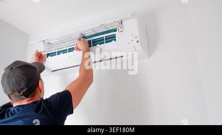 Air conditioner service. The technician checks the operation of the air conditioner. Filter replacement. Cleaning. Stock Photo