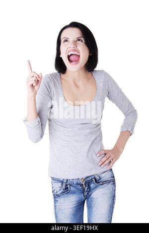 Surprised woman screaming and pointing at copy space. Isolated on white background Stock Photo