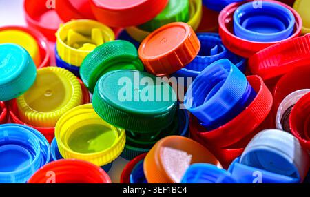 Different sorts of colorful plastic bottle caps. Recycling. Stock Photo