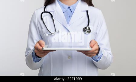 Unrecognizable Doctor Holding Tablet Standing In Studio, Panorama Stock Photo