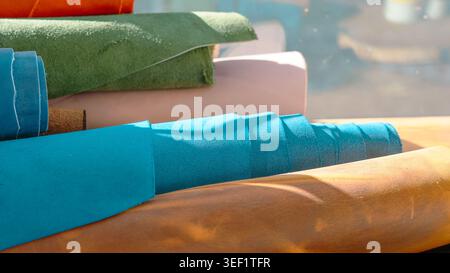 Colorful leather rolls for craft and handmade production in a workshop. Stock Photo