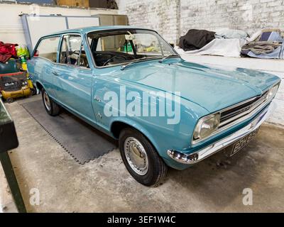 Light blue Vauxhall Viva HB estate classic car parked inside a garage workshop in the UK Stock Photo