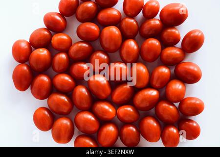 A pile of ripe cherry tomatoes on a white background Stock Photo