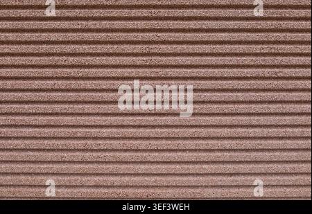 Striped brown concrete aggregate wall. Full frame. Background and texture. Stock Photo