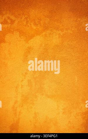 A stucco wall with deep orange and yellow colors - background photography Stock Photo