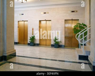 Elevator lobby interior in apartment flat building with gold doors, Philadelphia USA Stock Photo