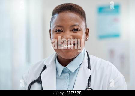 Portrait, black woman and hospital with doctor for healthcare, medical service and smile in office. Female practitioner, employee and clinic for Stock Photo