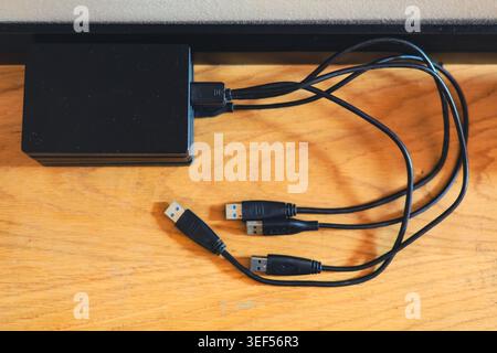 Stack of portable external hard drives representing digital storage backup and data security technology Stock Photo