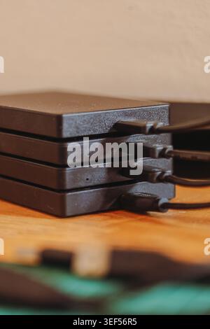 Stack of portable external hard drives representing digital storage backup and data security technology Stock Photo