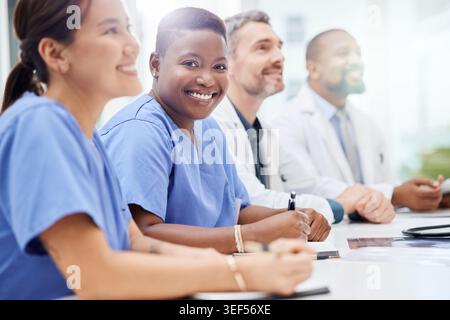 Meeting, audience and team of doctors and nurses in hospital for seminar, conference or presentation. People, portrait and group of healthcare Stock Photo