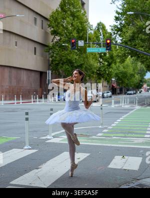 Ballerina dancing on quiet city crosswalk Stock Photo