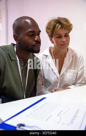 Colleagues collaborating on data analysis during a business meeting Stock Photo