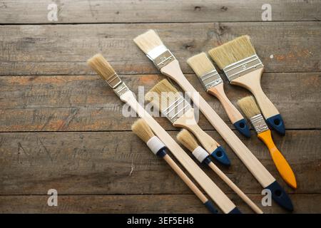 Paint brushes on rustic wooden background. Stock Photo