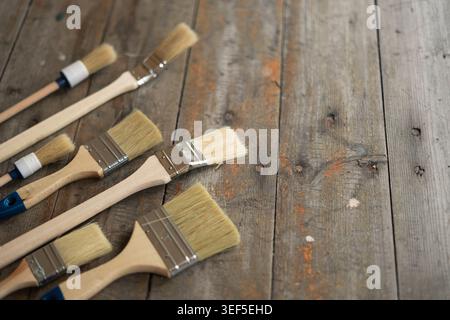 Paint brushes on rustic wooden background. Stock Photo