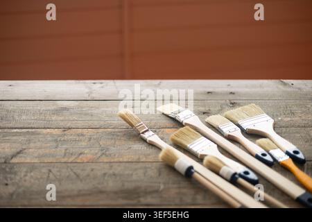 Paint brushes on rustic wooden background. Stock Photo