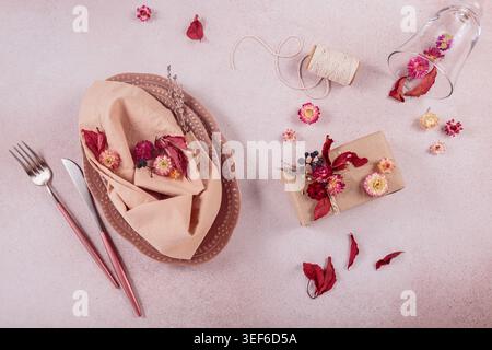 Process of decorating festive autumn table setting with dried flowers Stock Photo
