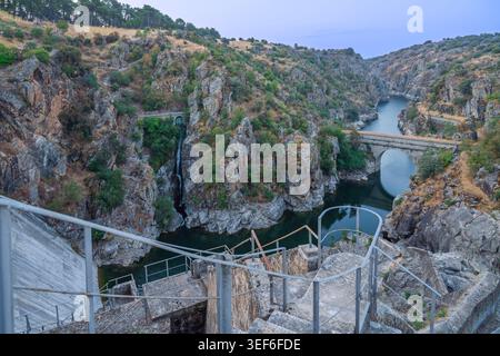 the-road-rises-slightly-above-a-narrow-passage-between-reservoirs