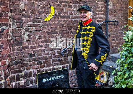 During the spray-painting event, Thomas Baumgärtel talks about his life as a banana-spray-painter. For the major project ‘Niederrheintour’, he is wearing a remake of a Jimi Hendrix hussar jacket to the exhibition openings. Grevenbroich, Nordrhein-Westfalen, Deutschland Stock Photo