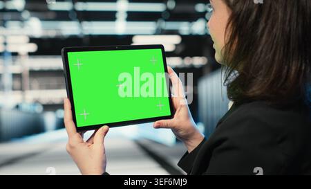 Isolated screen tablet in data center used by software developer to conduct security audit on IT infrastructure. Chroma key device in server hub used by worker to verify firewall protection Stock Photo