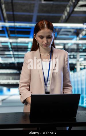 Data center cybersecurity specialist deploying protection against network malware threats. Server room technician auditing systems for virus vulnerabilities and computer bugs Stock Photo
